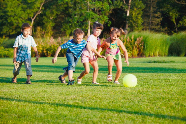 Young children play a team game with a ball
