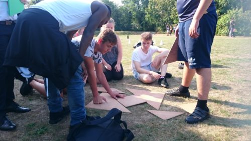 Teenagers solving a puzzle challenge as a team