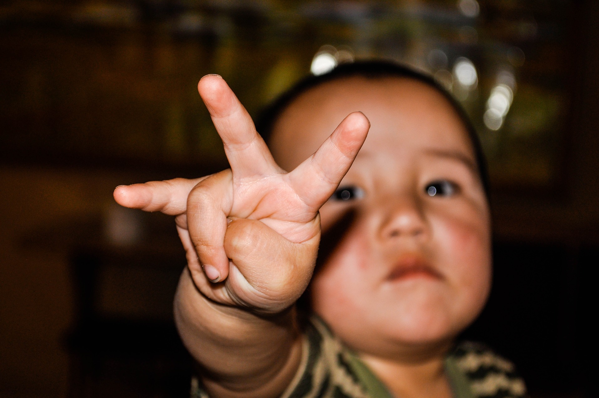 Little boy holding up three fingers