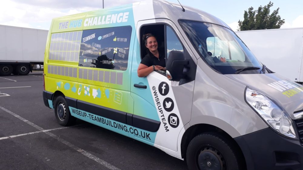 WiseUp Team Building Van parked at school with Instructor in driver seat